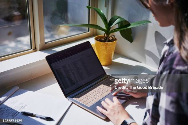 close up woman using laptop computer - touchpad foto e immagini stock