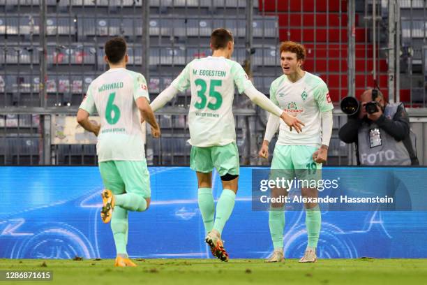 Maximilian Eggestein of Werder Bremen celebrates with teammate Josh Sargent after scoring his team's first goal during the Bundesliga match between...