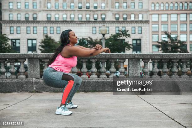 woman getting healthy and fit training outdoors - crouching stock pictures, royalty-free photos & images