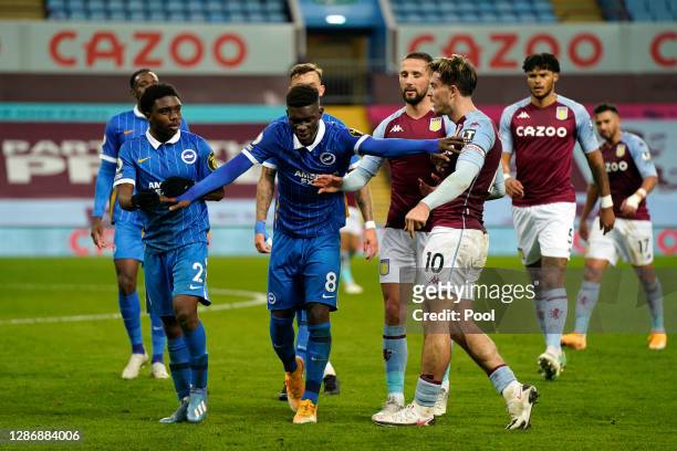 Yves Bissouma of Brighton and Hove Albion seperates teammate Jack Grealish of Aston Villa during the Premier League match between Aston Villa and...
