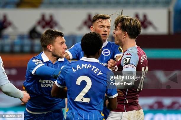 Jack Grealish of Aston Villa clashes with Joel Veltman, Dan Burn and Tariq Lamptey of Brighton and Hove Albion during the Premier League match...