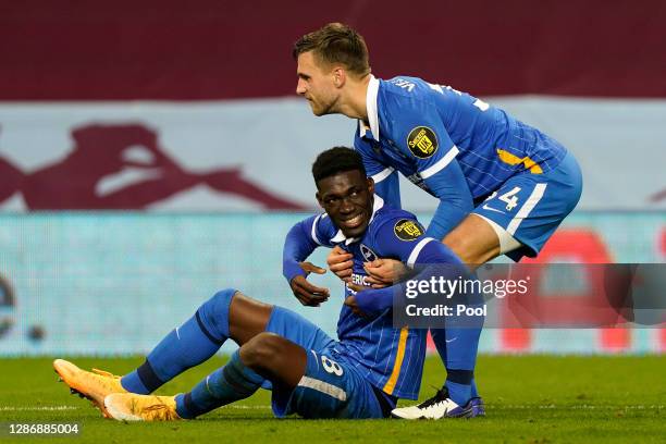 Yves Bissouma and Joel Veltman of Brighton and Hove Albion celebrate following their team's victory in the Premier League match between Aston Villa...