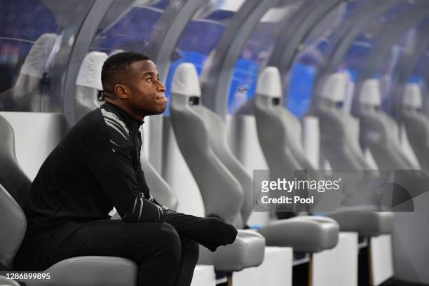 Youssoufa Moukoko of Dortmund takes a rest on the bench before warming up for the Bundesliga match between Hertha BSC and Borussia Dortmund at...