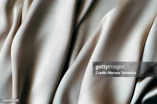 background with a beautiful wavy silver fabric. - nylon 個照片及圖片檔