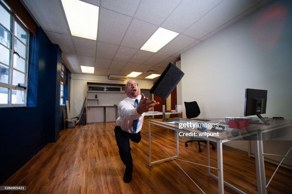 Office Goof falling and spectaculary drops a digital tablet in an office 1of2