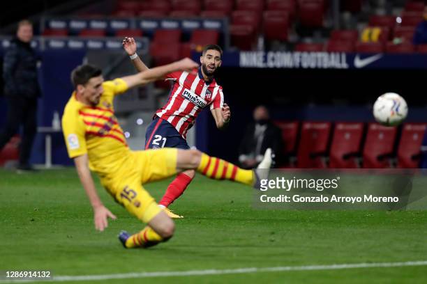 Yannick Carrasco of Atletico de Madrid scores his team's first goal past Clement Lenglet of FC Barcelona during the La Liga Santander match between...