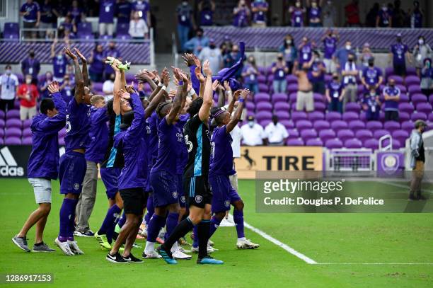 Orlando City SC react to their supporters after defeating New York City FC during penalty kicks of Round One of the MLS Cup Playoffs at Exploria...