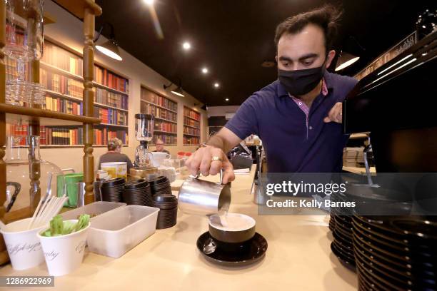 Harsh Mehta, owner of Coffylosophy cafe prepares coffees for customers after being in lockdown for 4 days on November 22, 2020 in Adelaide,...