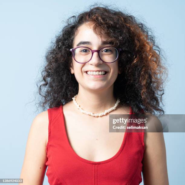 portrait of young middle eastern woman with long curly hair - curly red hair glasses stock pictures, royalty-free photos & images