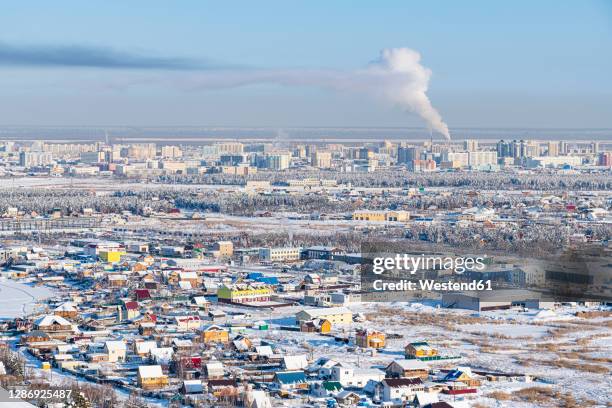 russia, republic of sakha, yakutsk, snow-covered city in winter - republik sacha stock-fotos und bilder