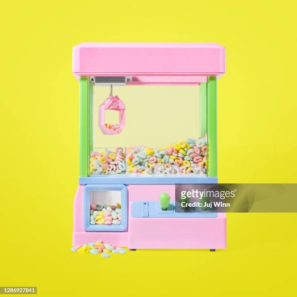 cereal in a toy claw machine - claw machine stock pictures, royalty-free photos & images