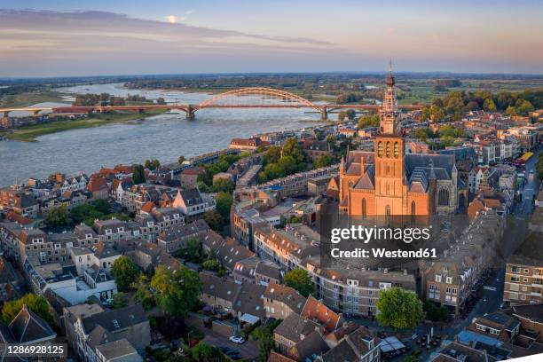 netherlands, gelderland, nijmegen, aerial view of saint stephens church and surrounding buildings at dusk - 奈美根 個照片及圖片檔