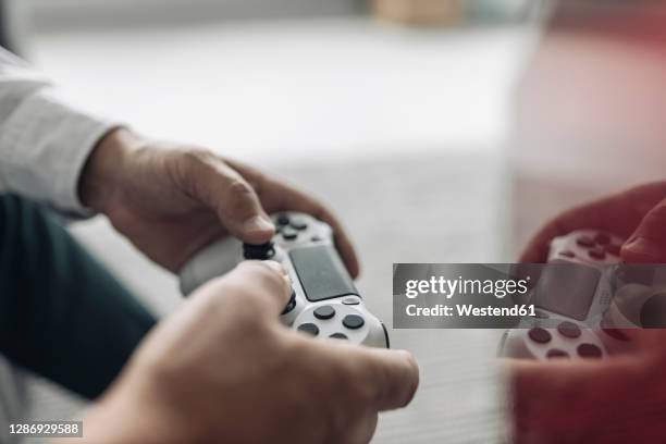 businessman hands holding video game remote control at office - game console stockfoto's en -beelden