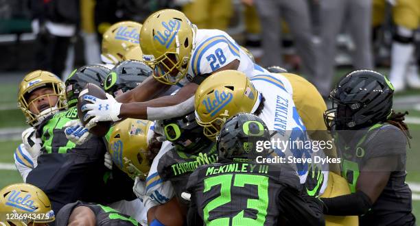 Brittain Brown of the UCLA Bruins dives into the end zone for a touchdown during the second half of the game against the Oregon Ducks at Autzen...