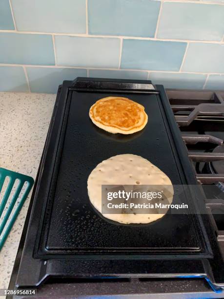 pancakes on griddle - griddle stock pictures, royalty-free photos & images