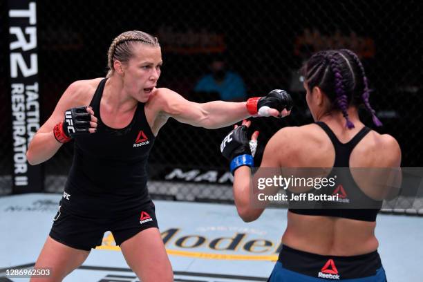 Katlyn Chookagian punches Cynthia Calvillo in their women's flyweight bout during the UFC 255 event at UFC APEX on November 21, 2020 in Las Vegas,...