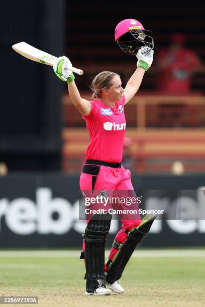 Alyssa Healy of the Sixers celebrates scoring a century during the Women's Big Bash League WBBL match between the Melbourne Stars and the Sydney...