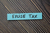 Excise Tax write on sticky notes isolated on office desk.