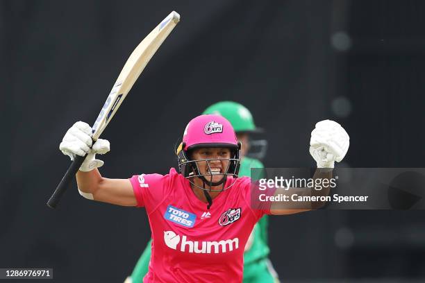 Angela Reakes of the Sixers celebrates hitting the winning runs during the Women's Big Bash League WBBL match between the Melbourne Stars and the...