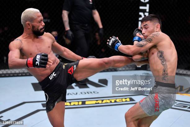 Deiveson Figueiredo of Brazil kicks Alex Perez in their flyweight championship bout during the UFC 255 event at UFC APEX on November 21, 2020 in Las...