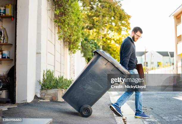 hauling garbage - wheelie bin stock pictures, royalty-free photos & images