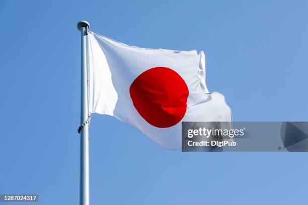 japanese flag against clear sky - japanische flagge stock-fotos und bilder