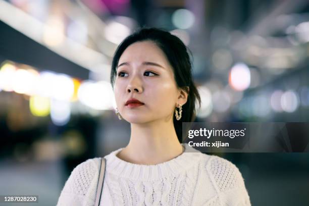 portrait of young woman at night street - korean street stock pictures, royalty-free photos & images