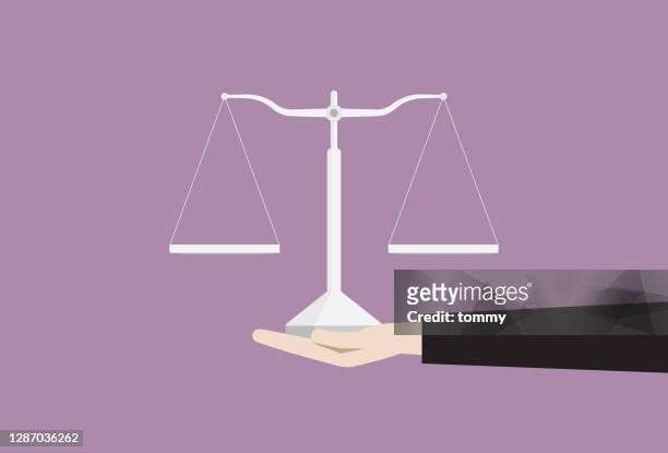 hand holding an equal-arm balance - human rights lawyer stock illustrations