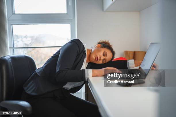 african-american businesswoman falling a sleep in an office - women in slips stock pictures, royalty-free photos & images