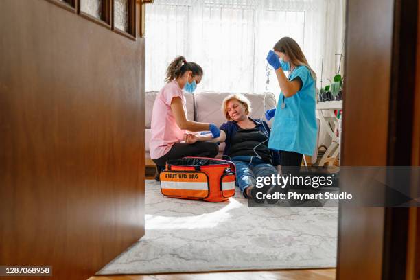 paramedics give first aid to an unconscious elderly woman - unconscious stock pictures, royalty-free photos & images