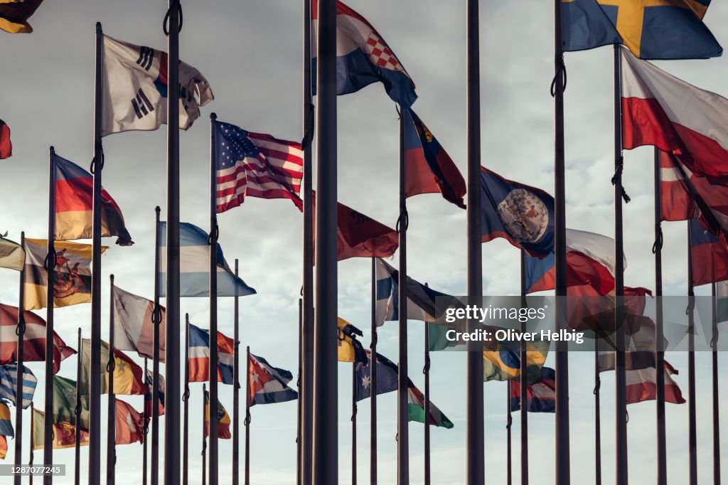 Flags of different nations on high flagpoles