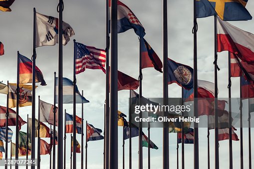Flags of different nations on high flagpoles Flags of different nations on high flagpoles