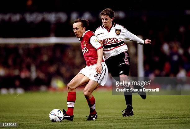 Lee Dixon of Arsenal is closed down by Ole Gunnar Solskjaer of Manchester United in the FA Cup semi-final replay at Villa Park in Birmingham,...