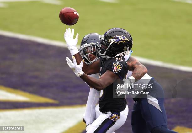 Amani Hooker of the Tennessee Titans breaks up a pass for Marquise Brown of the Baltimore Ravens during the game at M&T Bank Stadium on November 22,...