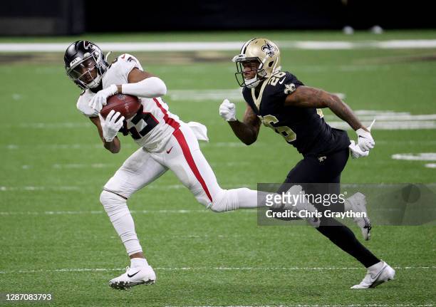 Russell Gage of the Atlanta Falcons makes the catch as P.J. Williams of the New Orleans Saints defends in the second quarter at Mercedes-Benz...