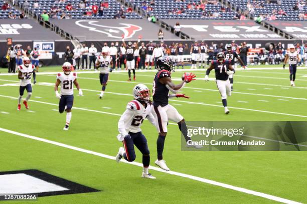 Brandin Cooks of the Houston Texans makes a reception in the second quarter against Stephon Gilmore of the New England Patriots that was called back...