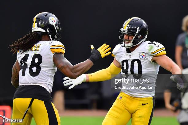 Watt and Bud Dupree of the Pittsburgh Steelers react during the second half against the Jacksonville Jaguars at TIAA Bank Field on November 22, 2020...