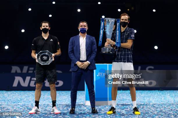 Daniil Medvedev of Russia poses with the winners trophy and Dominic Thiem of Austria poses with runners up plate with Andrea Gaudenzi, Chairman of...