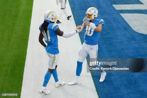 Mike Williams of the Los Angeles Chargers celebrates with Justin Herbert after Williams' touchdown during the first half against the New York Jets at...