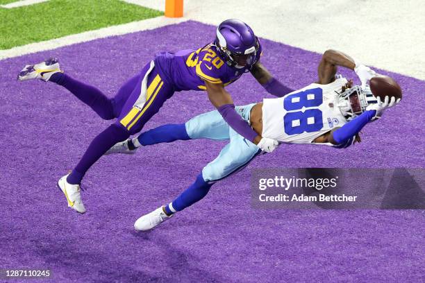 CeeDee Lamb of the Dallas Cowboys pulls in a touchdown pass against Jeff Gladney of the Minnesota Vikings during their game at U.S. Bank Stadium on...