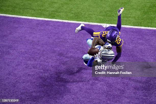 CeeDee Lamb of the Dallas Cowboys pulls in a touchdown pass against Jeff Gladney of the Minnesota Vikings during their game at U.S. Bank Stadium on...