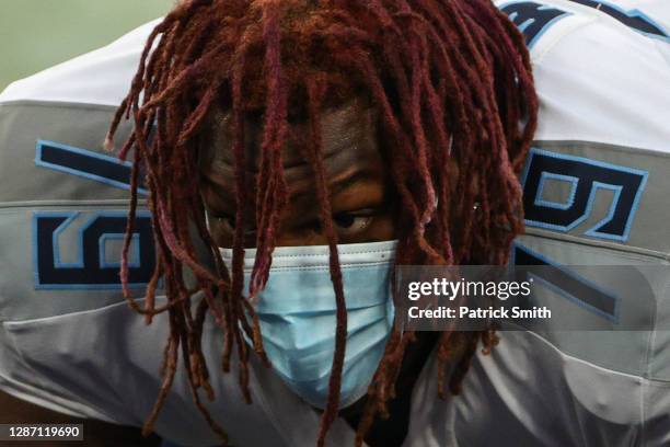 Offensive tackle Isaiah Wilson of the Tennessee Titans wears a face covering as he celebrates after defeating the Baltimore Ravens at M&T Bank...