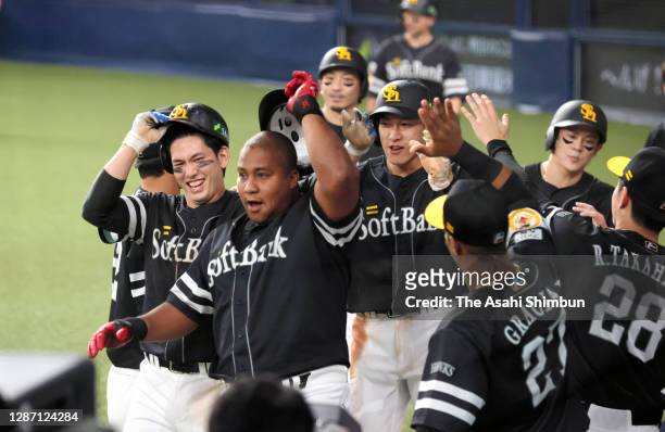 Alfredo Despaigne of the Fukuoka SoftBank Hawks celebrates with his team mates after hitting a grand slam to make it 11-2 in the 7th inning during...