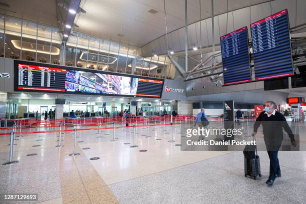 People are seen at Melbourne Airport checking in for flights to New South Wales on November 23, 2020 in Melbourne, Australia. COVID-19 restrictions...
