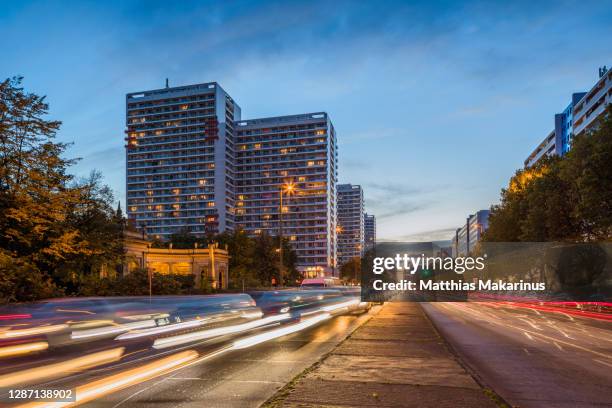 berlin night city skyline street scene with high rise residential buildings and traffic jam - plattenbau stock-fotos und bilder