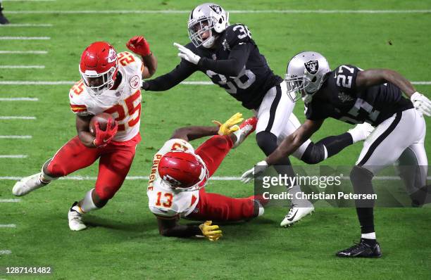 Running back Clyde Edwards-Helaire of the Kansas City Chiefs rushes for a touchdown as strong safety Jeff Heath and cornerback Trayvon Mullen Jr. #27...
