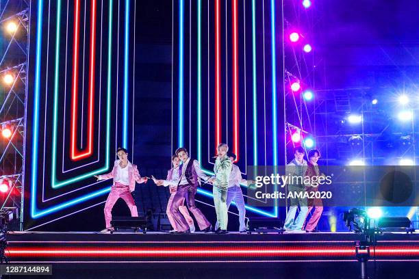 In this image released on November 22, J-Hope, Jin, RM, Jimin, V, Suga, and Jungkook of BTS perform onstage for the 2020 American Music Awards on...