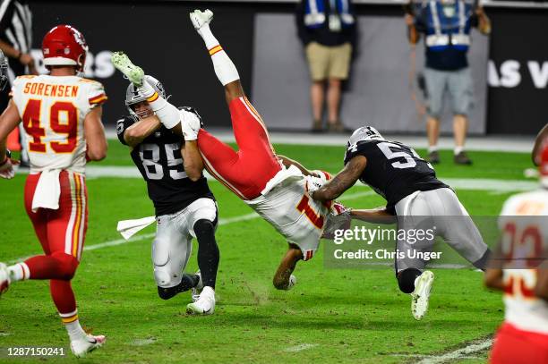 Wide receiver Demarcus Robinson of the Kansas City Chiefs is tackled by tight end Derek Carrier and middle linebacker Raekwon McMillan of the Las...