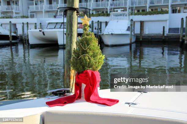 christmas tree on a boat in a marina - festival float stock pictures, royalty-free photos & images