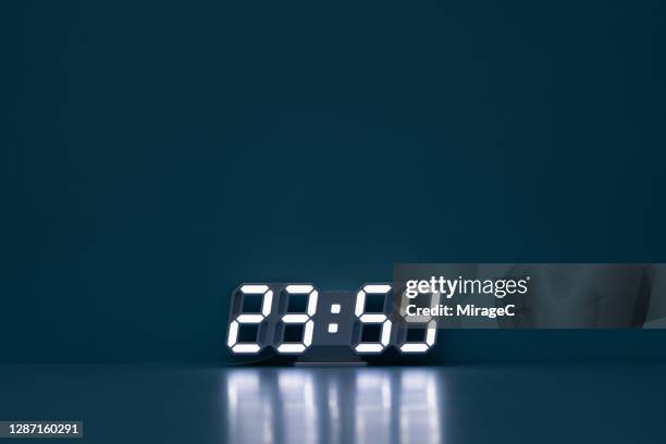 midnight 23:59 the last minute of a day - digital clock stock pictures, royalty-free photos & images